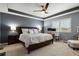 Spacious primary bedroom featuring a ceiling fan, neutral color palette, and a dedicated desk area at 22336 E Bellewood Dr, Aurora, CO 80015