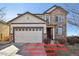 Charming two-story home featuring a stone facade, two-car garage, and well-maintained landscaping at 22336 E Bellewood Dr, Aurora, CO 80015