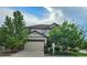 Inviting two-story home with a two-car garage, stone accents, and mature trees in a well-maintained neighborhood at 22336 E Bellewood Dr, Aurora, CO 80015