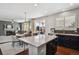Open floor plan with kitchen island, dining table, and living room at 22336 E Bellewood Dr, Aurora, CO 80015