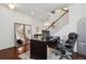 Office space with wood floors, a large desk, and view of staircase at 22336 E Bellewood Dr, Aurora, CO 80015