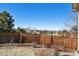 A backyard view features a tall wooden fence, rock bed, and community views at 22336 E Bellewood Dr, Centennial, CO 80015