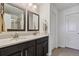 Bright bathroom with double sinks, granite countertops, dark cabinets and tiled floors at 22336 E Bellewood Dr, Aurora, CO 80015