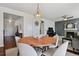 Open dining area with stylish pendant lighting, fireplace and living room at 22336 E Bellewood Dr, Centennial, CO 80015