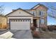 Charming two-story home featuring a stone facade, a two-car garage, and well-maintained landscaping at 22336 E Bellewood Dr, Centennial, CO 80015