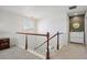 Open hallway with neutral carpet, white railing, chandelier and painted walls at 22336 E Bellewood Dr, Centennial, CO 80015