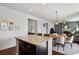 Open concept kitchen featuring dark cabinets, stainless steel appliances, and a center island with seating at 22336 E Bellewood Dr, Centennial, CO 80015