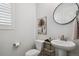 Chic powder room featuring a pedestal sink and modern decor at 22336 E Bellewood Dr, Aurora, CO 80015