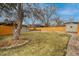 Large backyard with a wooden fence, mature trees, and well-kept lawn at 9405 W 54Th Pl, Arvada, CO 80002