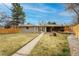 Home exterior showcasing a spacious backyard with a well-maintained lawn and modern wooden fence at 9405 W 54Th Pl, Arvada, CO 80002