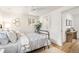 Comfortable bedroom featuring a queen bed, white ceiling fan, and view of the ensuite bathroom at 9405 W 54Th Pl, Arvada, CO 80002