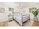 Bright bedroom with a black metal frame bed, white nightstand, and stylish decor accents at 9405 W 54Th Pl, Arvada, CO 80002