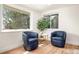 Cozy sitting area with comfortable chairs, large windows and hardwood flooring at 9405 W 54Th Pl, Arvada, CO 80002