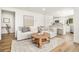Bright, modern living room with a comfortable sofa and a view into the updated kitchen at 9405 W 54Th Pl, Arvada, CO 80002