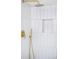 Modern shower with gold fixtures and white tile at 9405 W 54Th Pl, Arvada, CO 80002