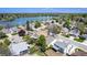 Scenic aerial view of a residential community, showcasing homes near a beautiful lake and lush greenery at 8281 Johnson St, Arvada, CO 80005