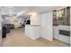 Finished basement with sofa and cabinets and utility closet with laundry appliances at 8281 Johnson St, Arvada, CO 80005