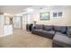 Finished basement with sectional sofa and built-in shelves and storage at 8281 Johnson St, Arvada, CO 80005