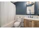 Well-lit bathroom featuring modern fixtures, a tub with shower, and stylish tile at 8281 Johnson St, Arvada, CO 80005