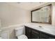 Bathroom featuring tiled vanity, a large mirror, and decorative trim at 8281 Johnson St, Arvada, CO 80005