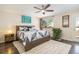 Bedroom with wood floors, neutral walls, and large window for natural light at 8281 Johnson St, Arvada, CO 80005