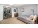 Modern bedroom featuring a wine refrigerator, neutral decor, and soft carpet at 8281 Johnson St, Arvada, CO 80005