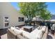 Comfortable patio set with cushions on an elevated deck is ready for the next gathering of friends at 8281 Johnson St, Arvada, CO 80005