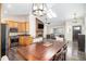 Well lit dinning room leads into a gourmet kitchen, featuring wood cabinets, stainless steel appliances and hardwood floors at 8281 Johnson St, Arvada, CO 80005