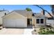 Charming single-Gathering home with a two-car garage and well-maintained landscaping under a clear blue sky at 8281 Johnson St, Arvada, CO 80005