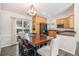 Gourmet kitchen with custom wood cabinets, stainless steel appliances, and open layout to the dining area at 8281 Johnson St, Arvada, CO 80005