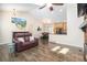 Open-concept living area with hardwood floors, vaulted ceiling, cozy seating, and an adjacent dining area at 8281 Johnson St, Arvada, CO 80005