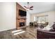 Spacious living room with a brick fireplace, vaulted ceilings, and hardwood floors with cozy furnishings at 8281 Johnson St, Arvada, CO 80005