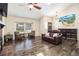 Bright and airy living room featuring hardwood floors, a cozy seating area, and large windows at 8281 Johnson St, Arvada, CO 80005