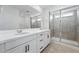 Bathroom with double sink vanity, large mirror, and a glass-enclosed shower at 17747 Prairie Peak Trl, Parker, CO 80134