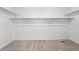 Walk-in closet featuring neutral carpet, overhead lighting, and metal shelving at 17747 Prairie Peak Trl, Parker, CO 80134