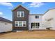 Back exterior with white trim, sliding glass door, and view of yard and neighborhood at 17747 Prairie Peak Trl, Parker, CO 80134