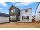 Rear exterior features a deck with white railing, gray and white siding, and yard at 17747 Prairie Peak Trl, Parker, CO 80134