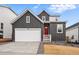 Charming two-story home with a two car garage, red front door, and well-manicured landscaping at 17747 Prairie Peak Trl, Parker, CO 80134