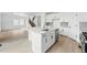 Bright, modern kitchen with white cabinets, stainless appliances, and large center island at 17747 Prairie Peak Trl, Parker, CO 80134