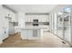 Modern kitchen with white cabinetry, stainless steel appliances, and an island with a quartz countertop at 17747 Prairie Peak Trl, Parker, CO 80134