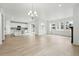 Bright open-concept living area with hardwood floors, large windows, and access to a modern kitchen at 17747 Prairie Peak Trl, Parker, CO 80134