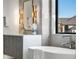 Modern bathroom with a free-standing bathtub and floating vanity at 6551 S Harlan Ct, Littleton, CO 80123