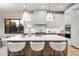 Modern kitchen with a large island and white shaker cabinets at 6551 S Harlan Ct, Littleton, CO 80123