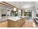 Modern kitchen with a large island and views into the living room and backyard at 6551 S Harlan Ct, Littleton, CO 80123