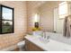 Stylish powder room with modern vanity and patterned wallpaper at 6551 S Harlan Ct, Littleton, CO 80123