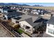 An aerial view of a single-Gathering home with a fenced backyard and solar panels on the roof at 17412 W 93Rd Pl, Arvada, CO 80007