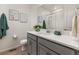 Modern bathroom with gray vanity, shower, and white countertop at 17412 W 93Rd Pl, Arvada, CO 80007