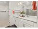 Stylish bathroom with double vanity sinks, hexagon tile floors, and a glass-enclosed shower at 17412 W 93Rd Pl, Arvada, CO 80007