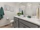 Well-lit bathroom featuring a sink, framed art, and shower for a modern and inviting space at 17412 W 93Rd Pl, Arvada, CO 80007