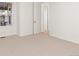 A sunny bedroom with carpet, closet and door to another room provides a bright and open space for relaxation at 17412 W 93Rd Pl, Arvada, CO 80007